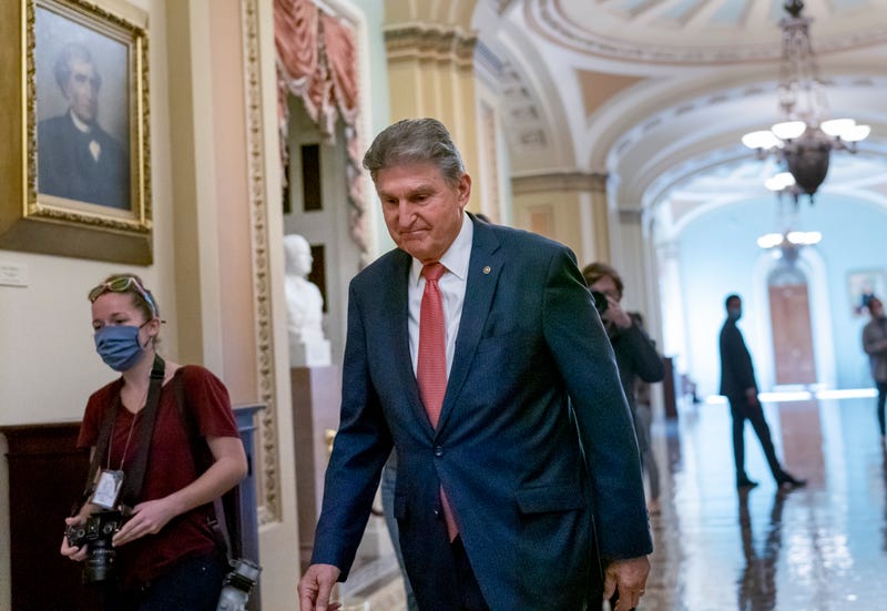Sen. Joe Manchin, D-W.Va., walks to a caucus lunch at the Capitol in Washington, Dec. 17, 2021.