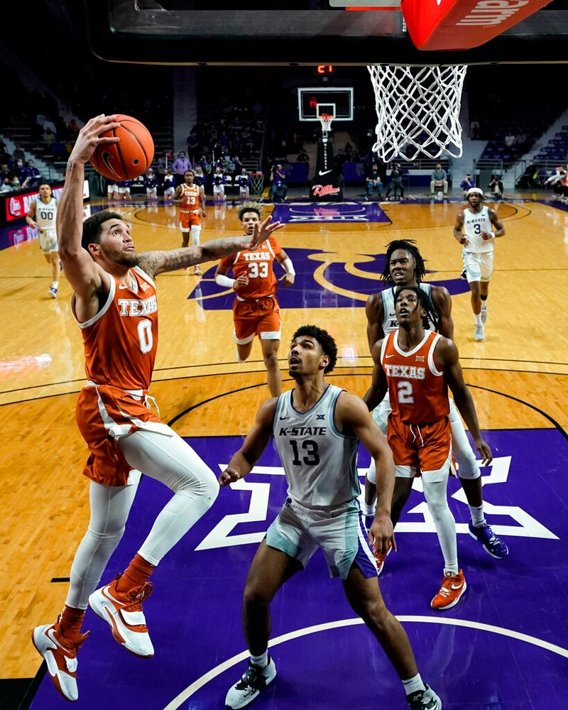 Texas forward Timmy Allen (0) dunks the ball over Kansas State guard Mark Smith (13)