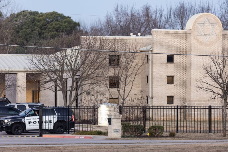 Police stand in front of the Congregation Beth Israel synagogue, Sunday, Jan. 16, 2022, in Colleyville, Texas.