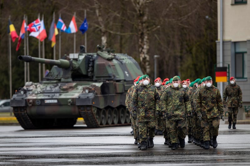 German Bundeswehr soldiers of the NATO enhanced forward presence battalion waits to greet German Defense Minister Christine Lambrecht upon his arrival at the Rukla military base some 62.12 miles west of the capital Vilnius, Lithuania, Tuesday, Feb. 22, 2022