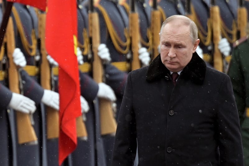 Russian President Vladimir Putin attends a wreath-laying ceremony at the Tomb of the Unknown Soldier, near the Kremlin Wall during the national celebrations of the 'Defender of the Fatherland Day' in Moscow, Russia, Wednesday, Feb. 23, 2022
