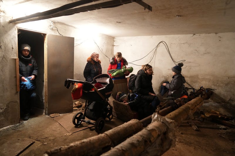 People gather in a shelter during Russian shelling, in Mariupol, Ukraine, Thursday, Feb. 24, 2022