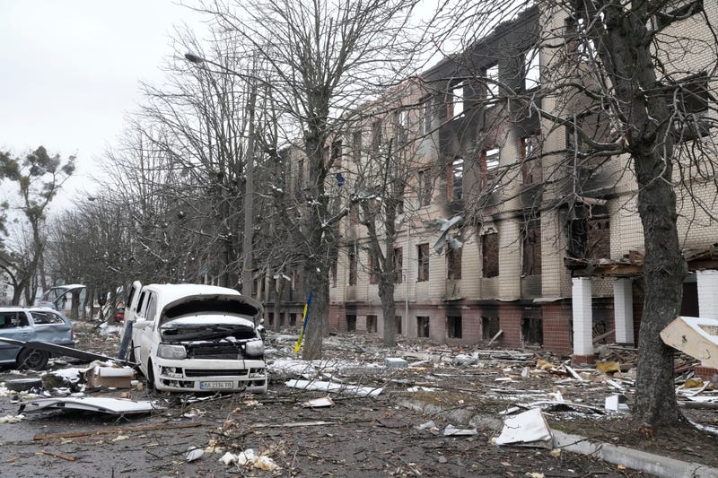 Damaged cars and a destroyed accommodation building are seen near a checkpoint in Brovary, outside Kyiv, Ukraine, Tuesday, March 1, 2022