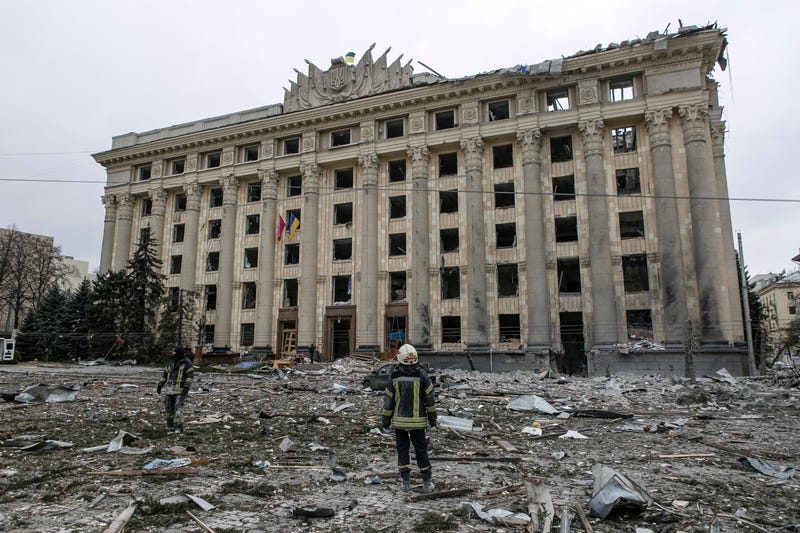 A member of the Ukrainian Emergency Service looks at the City Hall building in the central square following shelling in Kharkiv, Ukraine, Tuesday, March 1, 2022
