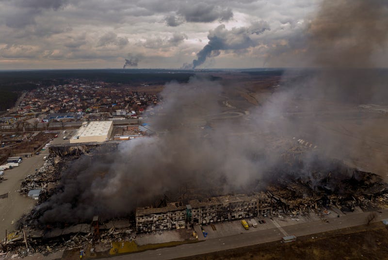 A factory and a store burn after having been bombarded in Irpin, in the outskirts of Kyiv, Ukraine, Sunday, March 6, 2022