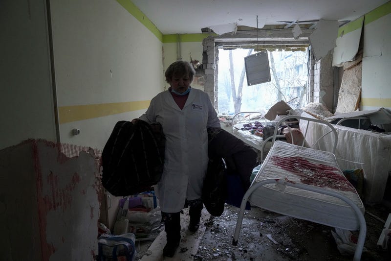 A medical worker walks inside of the damaged by shelling maternity hospital in Mariupol, Ukraine, Wednesday, March 9, 2022