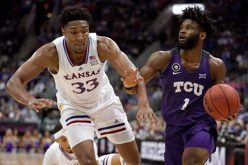 TCU guard Mike Miles (1) drives under pressure from Kansas forward David McCormack (33)