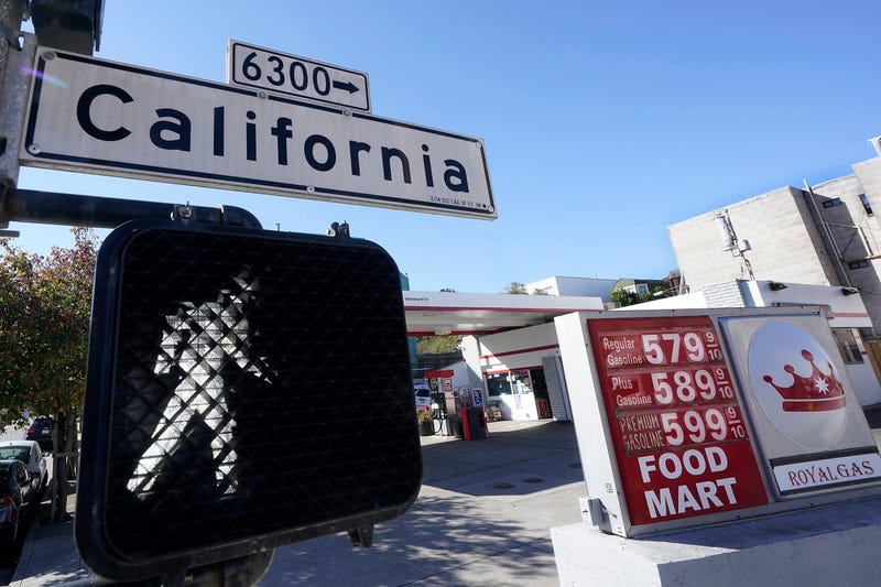 FILE - A California street sign is shown next to the price board at a gas station in San Francisco, on March 7, 2022. The average U.S. price of regular-grade gasoline shot up a whopping 79 cents over the past two weeks to $4.43 per gallon. Industry analyst Trilby Lundberg of the Lundberg Survey says Sunday, March 13, the new price exceeds by 32 cents the prior record high of $4.11 set in July 2008. Lundberg said gas prices are likely to remain high in the short term as crude oil costs soar amid global supply concerns following Russia's invasion of Ukraine. Nationwide, the highest average price for regular-grade is in the San Francisco Bay Area, at $5.79.