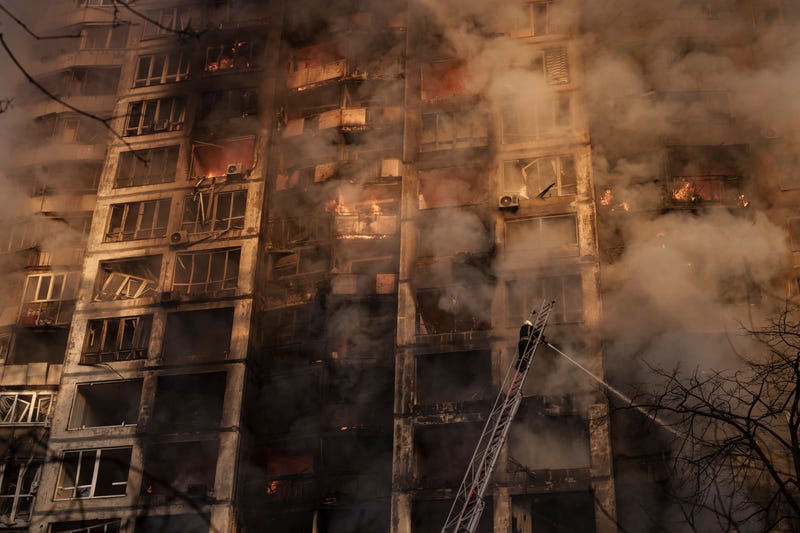 Firefighters extinguish fires in an apartment building after being hit by shelling in Kyiv, Ukraine, Tuesday, March 15, 2022