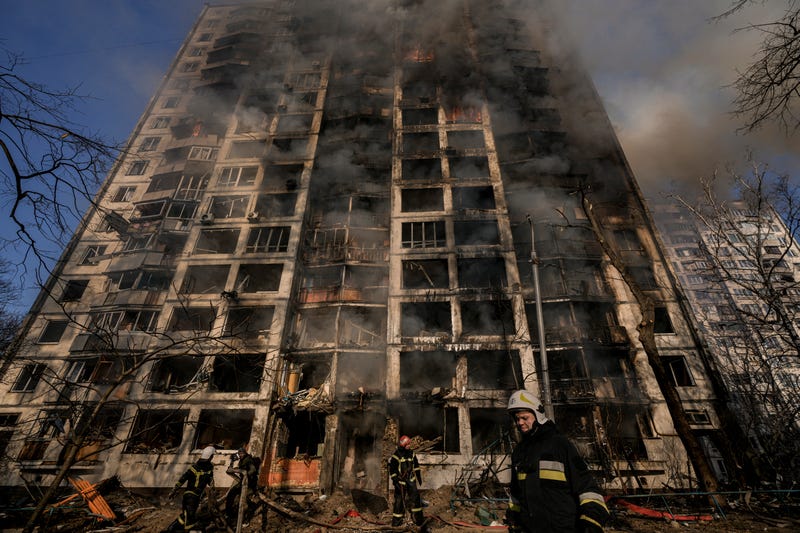 Firefighters work outside a destroyed apartment building after a bombing in a residential area in Kyiv, Ukraine, Tuesday, March 15, 2022