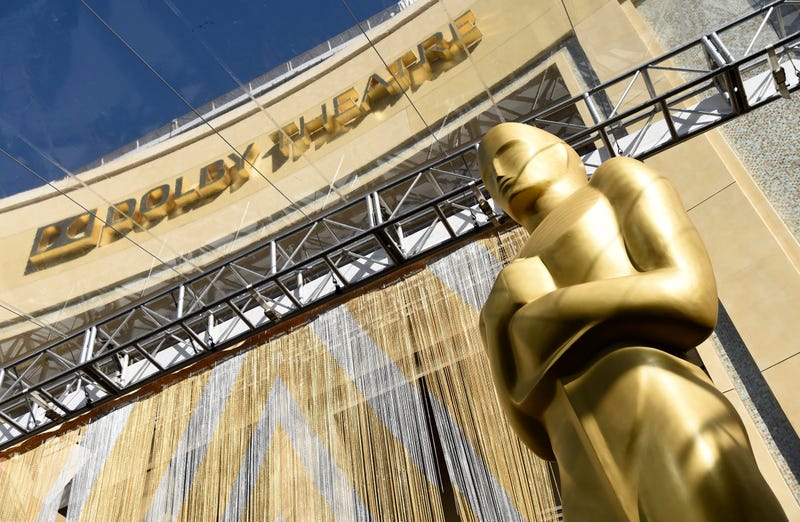FILE - An Oscar statue is pictured underneath the entrance to the Dolby Theatre on Feb. 24, 2016, in Los Angeles. The Oscars will be held on Sunday, March 27 at the Dolby Theatre in Los Angeles. The ceremony is set to begin at 8 p.m. ET and will be broadcast live on ABC.