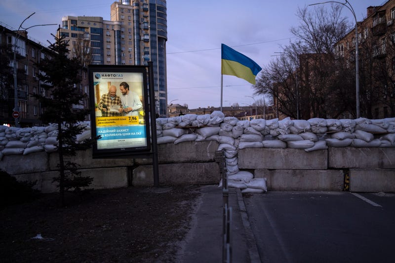 An advertising billboard in front of a barricade in Kyiv, Ukraine, Monday, March 21, 2022