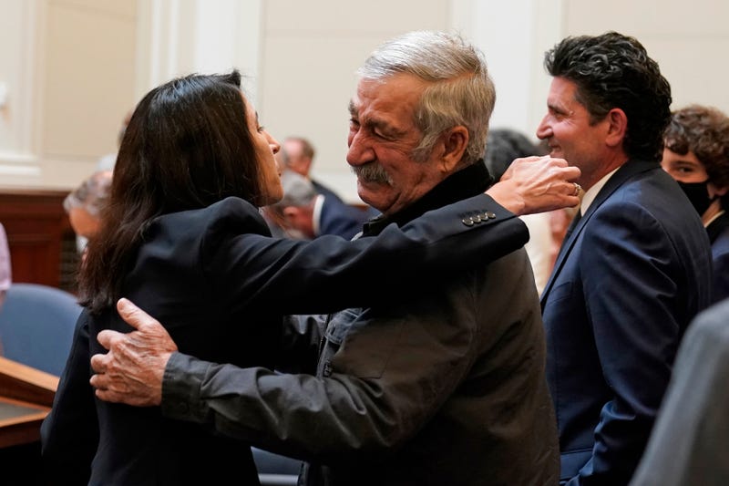 Justice Patricia Guerrero embraces her father, Jorge Guerrero, after being confirmed to the Supreme Court of California Tuesday, March 22, 2022, in San Francisco. Guerrero, the daughter of Mexican immigrants who grew up in the agricultural Imperial Valley will be the first Latina on the state's highest court. At right is her husband, Joe Dyson.