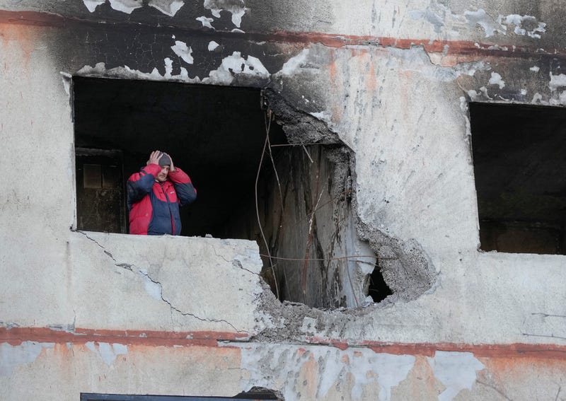 A man holds his head as he stands in his apartment in a multi-story house that was destroyed following a Russian attack in Kharkiv, Ukraine, Thursday, March 24, 2022