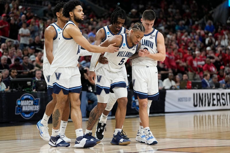 Villanova guard Justin Moore (5) is helped off the floor during the second half of a college basketball game against Houston in the Elite Eight round of the NCAA tournament on Saturday, March 26, 2022, in San Antonio.