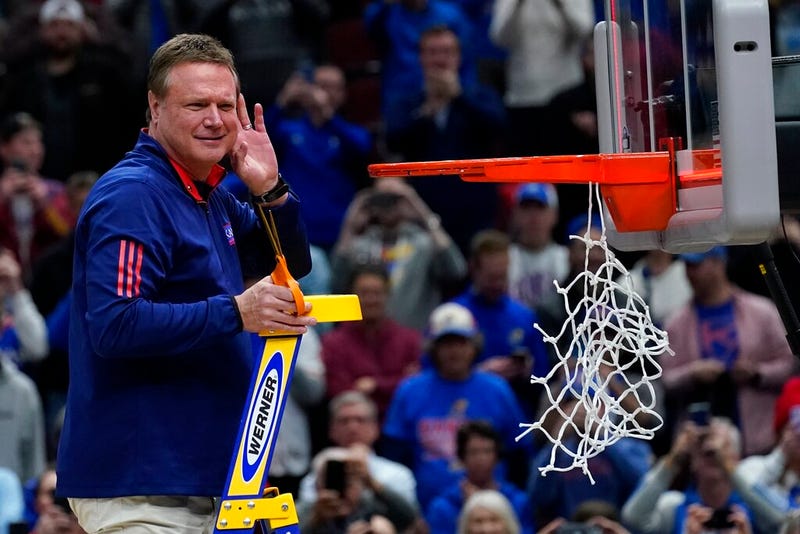 Kansas head coach Bill Self cuts down the net after a college basketball game in the Elite 8 round of the NCAA tournament against Miami