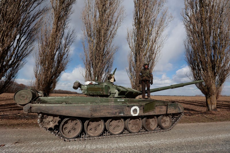A Ukrainian serviceman stands on a tank in the village of Lukyanivka, Kyiv region, Ukraine, Monday, March 27, 2022