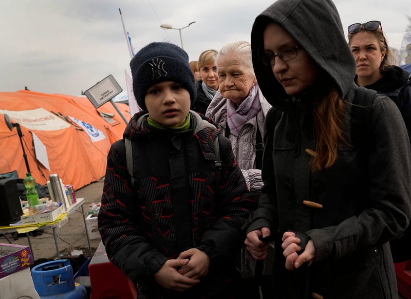 People stand in a queue after fleeing the war from neighbouring Ukraine at the border crossing in Medyka, southeastern Poland, on Tuesday, March 29, 2022