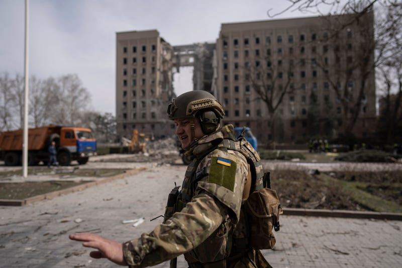 A Ukrainian soldier secures the area next to the regional government headquarters of Mykolaiv, Ukraine, following a Russian attack, on Tuesday, March 29, 2022