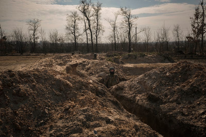 Ukrainian servicemen stand in trenches at a position north of the capital Kyiv, Ukraine, Tuesday, March 29, 2022