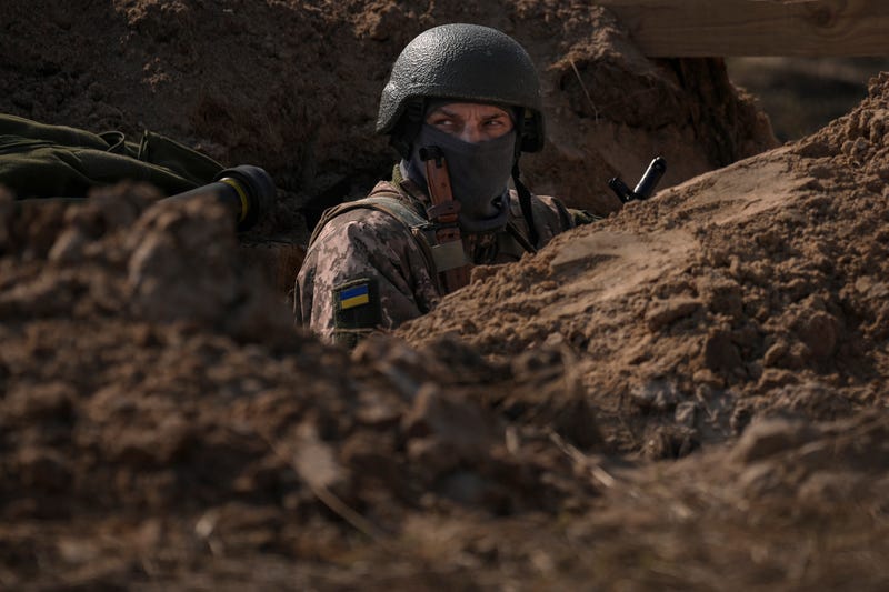 FILE - A Ukrainian serviceman stands in a trench at a position north of the capital Kyiv, Ukraine, Tuesday, March 29, 2022. The first face-to-face talks in two weeks between Russia and Ukraine began Tuesday in Turkey, raising flickering hopes there could be progress toward ending a war that has ground into a bloody campaign of attrition.