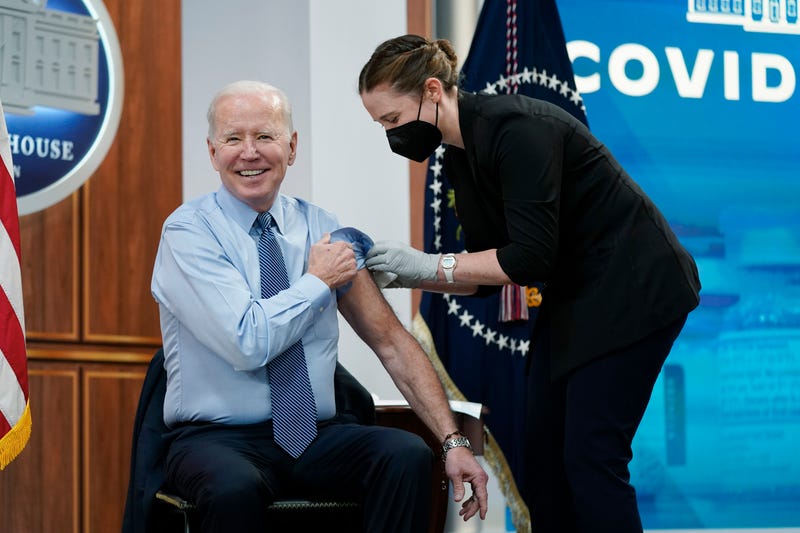 President Joe Biden reacts after receiving his second COVID-19 booster shot in the South Court Auditorium on the White House campus, Wednesday, March 30, 2022, in Washington