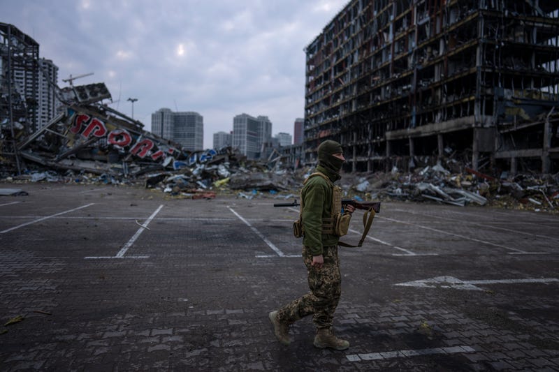 A soldier walks the amid the destruction caused after shelling of a shopping center last March 21 in Kyiv, Ukraine, Wednesday, March 30, 2022