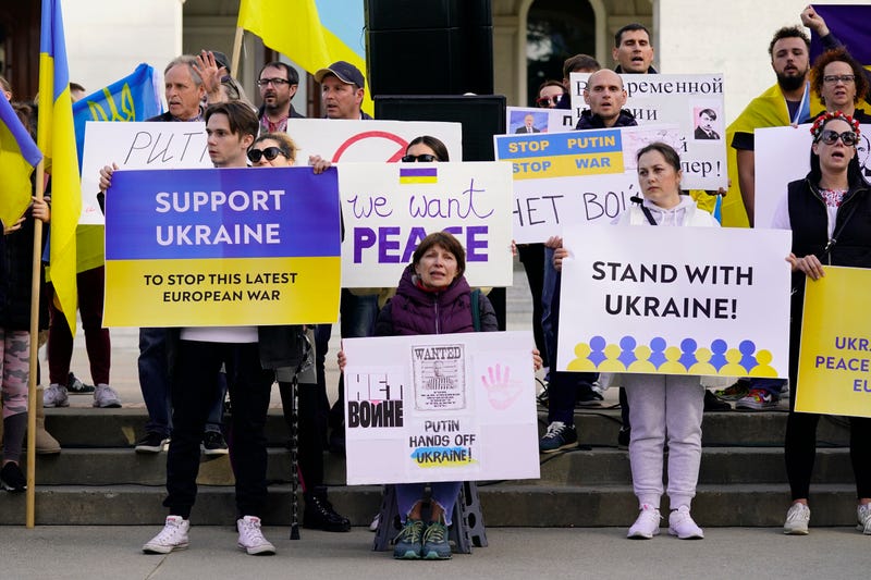 FILE— Members of the Ukrainian community and others gathered at the state Capitol to protest the Russian invasion of Ukraine at a rally n Sacramento, Calif., Thursday, Feb. 24, 2022. Roughly 18,000 Ukrainians live in the Sacramento region and the area is preparing for the possibility of many more Ukrainians arriving after U.S. President Joe Biden announced the nation will accept up to 100,000 refugees from the country.  