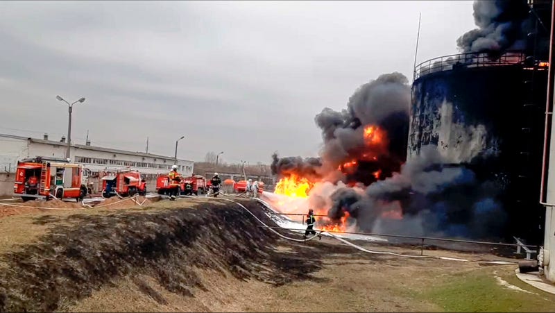 In this handout photo released by Russian Emergency Ministry Press Service on Friday, April 1, 2022, firefighters work at the site of fire at an oil depot in Belgorod region, Russia