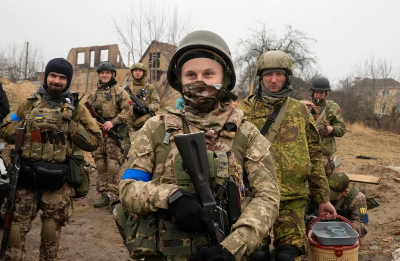 Ukrainian soldiers smile as they have a rest in Irpin close to Kyiv Friday, April 1, 2022