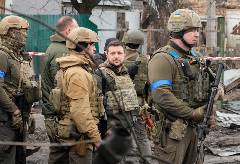 Ukrainian President Volodymyr Zelenskyy examines the site of a recent battle, in Bucha close to Kyiv, Ukraine, Monday, Apr. 4, 2022