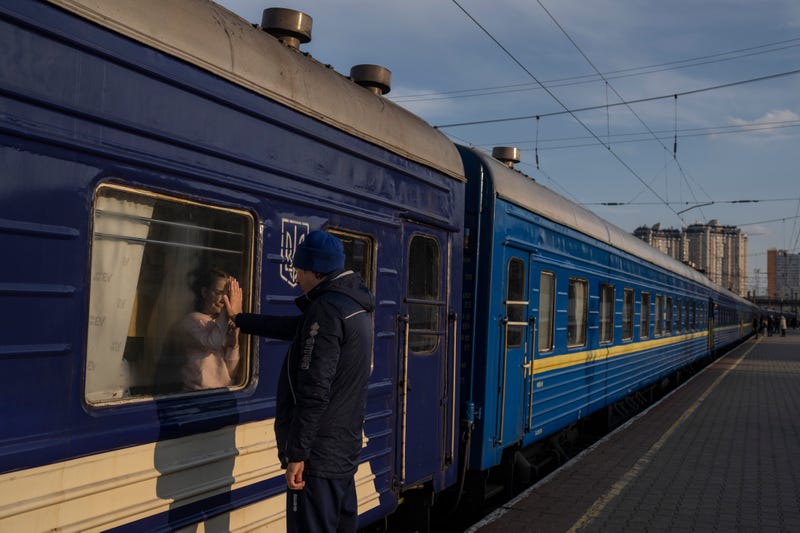 Ruslan Mishanin bids farewell to his nine year old daughter as the train with his family leaves for Poland, at the train station in Odesa, on Monday, April 4, 2022