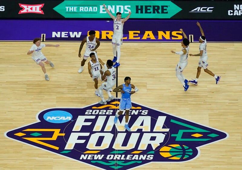 Kansas players celebrate a win over North Carolina after a college basketball game in the finals of the Men's Final Four NCAA tournament