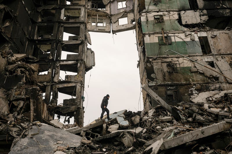 A resident looks for belongings in an apartment building destroyed during fighting between Ukrainian and Russian forces in Borodyanka, Ukraine, Tuesday, April 5, 2022