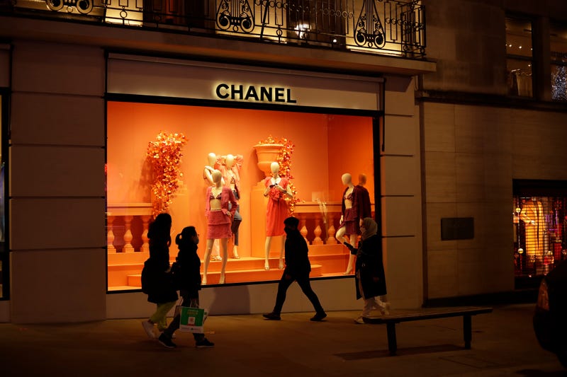 People walk past a Chanel shop on New Bond Street in London on Nov. 25, 2020