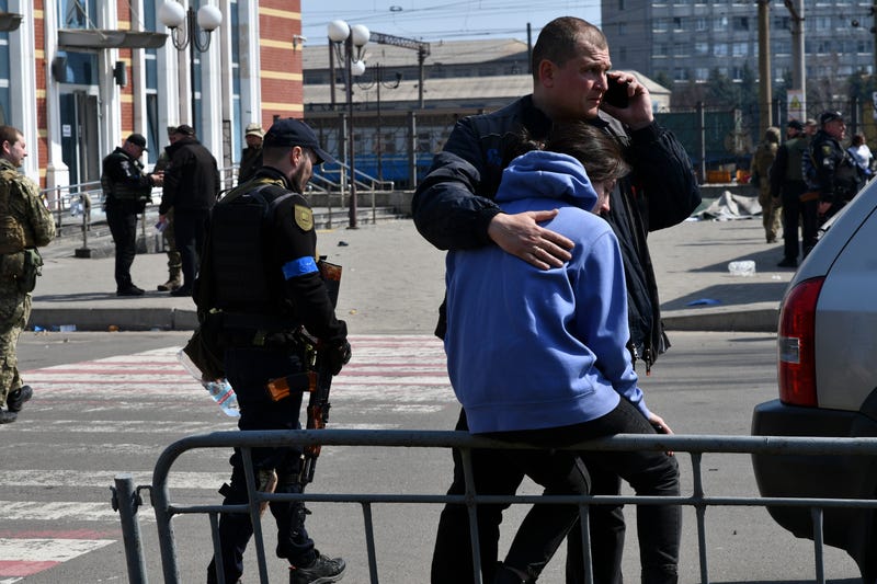 A man hugs a woman after Russian shelling at the railway station in Kramatorsk, Ukraine, Friday, April 8, 2022