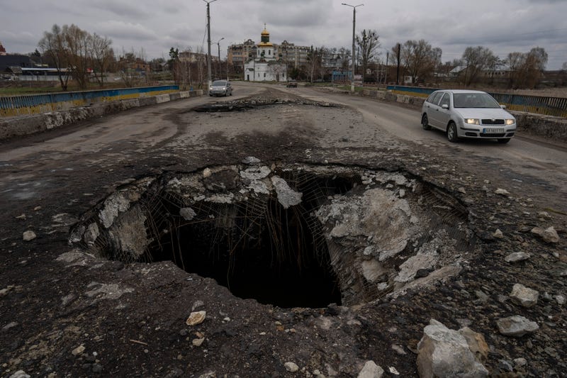 Cars drive near a damaged bridge following a Russian attack in the previous weeks in the town of Makarov, Kyiv region, Ukraine, on Sunday, April 10, 2022