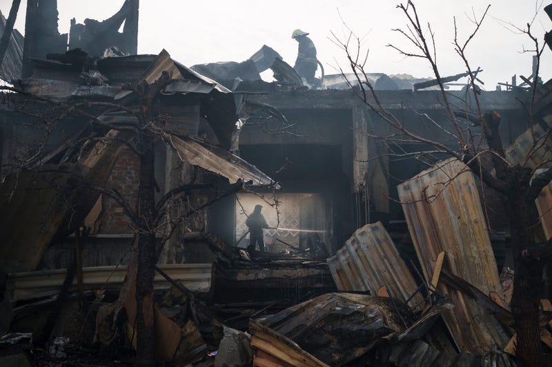 Firefighters work to extinguish a fire at a house after a Russian attack in Kharkiv, Ukraine, Monday, April 11, 2022.  