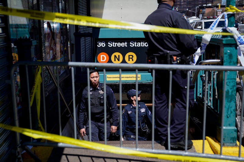 Emergency personnel gather at the entrance to a subway stop in the Brooklyn borough of New York, Tuesday, April 12, 2022