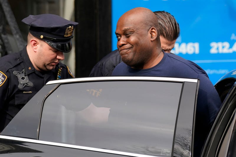 NYPD and law enforcement officials lead subway shooting suspect Frank R. James, 62, right, into a car and away from a police station, in New York, Wednesday, April 13, 2022
