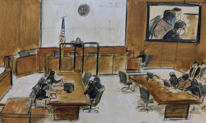 In this courtroom sketch, Frank James, seated at center of right table, and on left of the screen, upper right, appears during the brief proceeding in a federal court in the Brooklyn borough of New York, Thursday, April 14, 2022