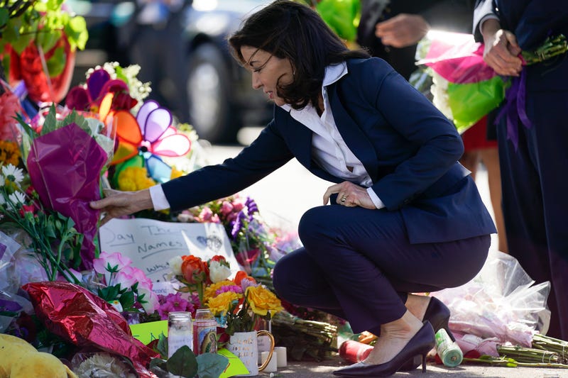Gov. Kathy Hochul looks at a memorial at the scene of a shooting at a supermarket as she pays respects to the victims of Saturday's shooting in Buffalo, N.Y., Tuesday, May 17, 2022