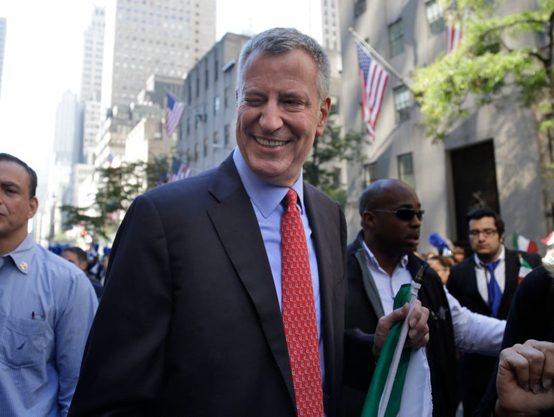 Then-Mayor Bill de Blasio winks at someone during the Columbus Day Parade in New York, Monday, Oct. 12, 2015