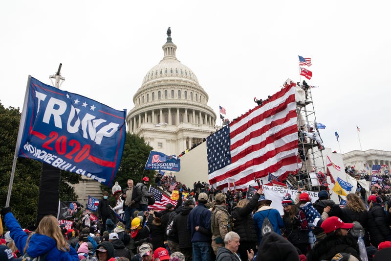 - Violent insurrectionists loyal to President Donald Trump stand outside the U.S. Capitol in Washington on Jan. 6, 2021. The public hearings of the House committee investigating the insurrection pose a challenge to Democrats seeking to maintain narrow control of Congress.