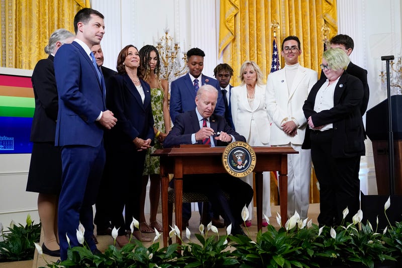 President Joe Biden signs an executive order at an event to celebrate Pride Month in the East Room of the White House