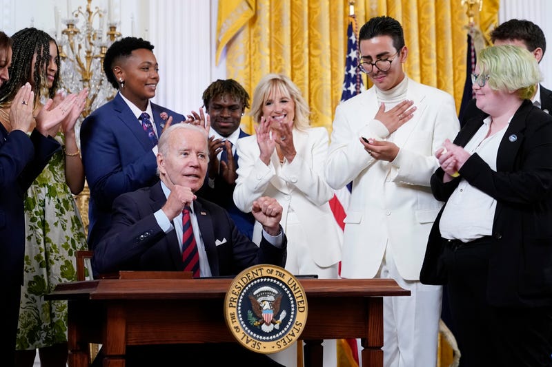 President Joe Biden signs an executive order at an event to celebrate Pride Month in the East Room of the White House