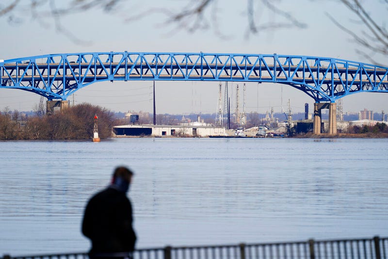 In this Wednesday, Feb. 24, 2021 file photo, a walker makes their way past the Interstate-95′s mile-long double-decked Girard Point Bridge in Philadelphia. A state court on Thursday, June 30, 2022, permanently blocked Gov. Tom Wolf's plan to toll as many as nine major bridges on interstates in Pennsylvania. The Girard Point Bridge was one of the bridges under consideration for tolling.