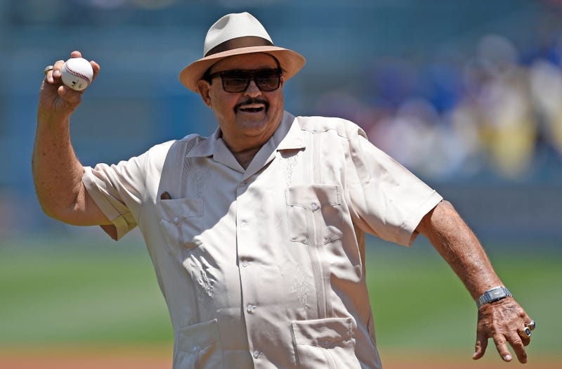 FILE - Los Angeles Dodgers scout Mike Brito throws out the first pitch prior to a baseball game between the Dodgers and the Colorado Rockies in Los Angeles, July 3, 2016. Brito, the top scout in Mexico for the Dodgers for nearly 45 years who discovered such talents as Fernando Valenzuela, current Dodgers pitcher Julio Urías and Yasiel Puig, died Thursday, July 7, 2022. He was 87. The team announced his death to the crowd before hosting the Chicago Cubs and held a moment of silence.