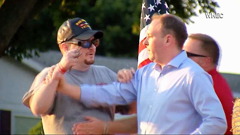 In this image taken from video provided by WHEC-TV, David Jakubonis, left, brandishes a sharp object as he attacks U.S. Rep. Lee Zeldin, right, as the Republican candidate for New York governor delivered a speech in Perinton, N.Y., Thursday, July 21, 2022.