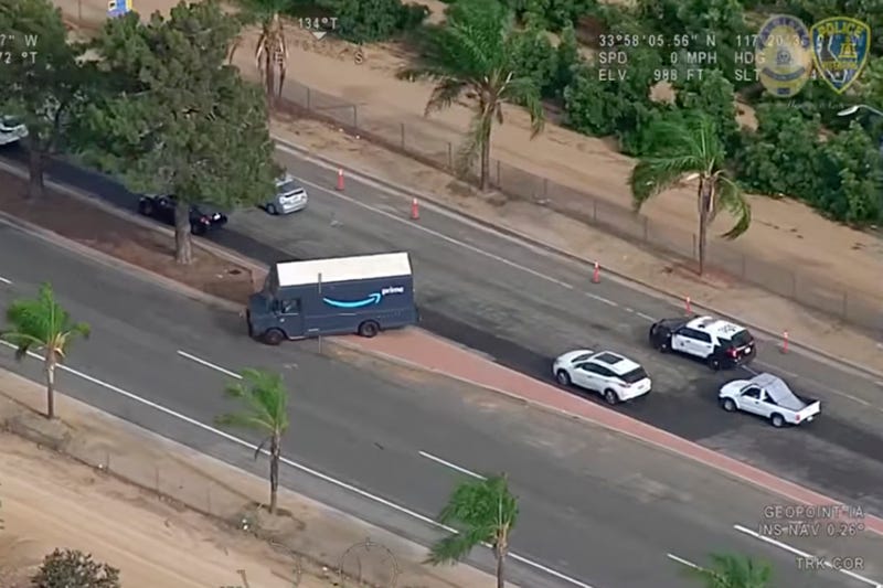 In this image taken from video released by the Riverside Police Department, police pursue of a man driving a stolen Amazon truck in Riverside, Calif., Monday, July 25, 2022. A Nevada man was arrested after police say he committed two brazen home invasion robberies, then stole an Amazon delivery truck and crashed into multiple cars as he led authorities on a chase throughout a Southern California city. Riverside police were able to use GPS tracking to locate the stolen truck.